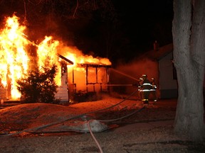 Fire crews work on containing a house fire at 210 Crawford Ave West Wednesday night.