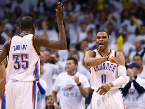 Thunder forward Kevin Durant (left) celebrates with teammate Russell Westbrook (right) after Westbrook scored against the Rockets during second half NBA playoff action in Oklahoma City on Wednesday, April 24, 2013. (Bill Waugh/Reuters)
