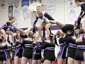 Dana Lockie grabs onto her teammates arms before helping them flip up into a lib for the Beaver Brae Bronco cheerleaders' pyramid. The cheer team guest-starred at the Kenora Aerialettes show on April 19.