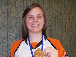 Tillsonburg resident and ringette player Taylor Campbell proudly shows off her bronze medal she and her team, the Cambridge Turbos won recently at the Canadian Ringette Championships in Fredericton, New Brunswick. KRISTINE JEAN/TILLSONBURG NEWS/QMI AGENCY