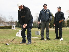 Ron Hare addresses the  ball on the first tee at Scenic City Golf Course Thursday while his friends Bob Honey, centre, and Peter Berney, right, look on. Most golf courses in the area are just beginning to open for the season. TRACEY RICHARDSON Photo, The Sun Times.