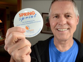 Tom Moran of Owen Sound holds up a Spring Sprint promotional button in Owen Sound on Wednesday, April 24, 2013 in support of the Brain Tumour Foundation of Canada. Moran is in the process of participating in the Spring Sprint a series of fund-raising walks in support of the Brain Tumour Foundation of Canada.  Moran is recovering from a brain tumour. (JAMES MASTERS The Sun Times)