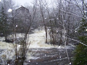 This photograph of the South River near the dam, showing rushing waters, was taken Wednesday while it was snowing. Since then, however, the flood watch in the South River watershed has been downgraded. Water levels remain high but have stabilized and are starting to recede.