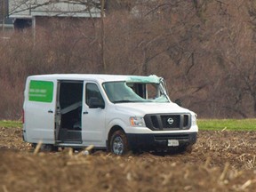 A van sits in a farmers field just north of Harrietsville Thursday. A large piece of sheet metal came from the roof of a farm wagon, which peeled off as the wagon was being towed southward on Elgin Rd. southeast of London. The metal sheeting struck the northbound van, going through the windshield and striking the male driver. The driver was taken to hospital with serious injuries. He was later pronounced dead. MIKE HENSEN/The London Free Press/QMI AGENCY