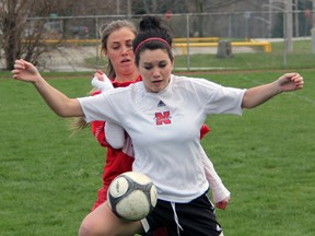Northern Viking Kayleigh Royer, front, shields the ball from Alanna Jacques of LCCVI in LSSAA senior girls soccer action Thursday, April 25, 2013 at LCCVI in Petrolia. PAUL OWEN/THE OBSERVER/QMI AGENCY