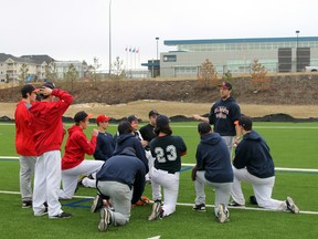 Fort McMurray Midget Oil Giants head coach Chad Marshall explains a drill at practice Thursday night at TC Park in Timberlea. The Midget Oil Giants will begin their season in the Nor’west League this weekend on the road against Okotoks Red. TREVOR HOWLETT/TODAY STAFF