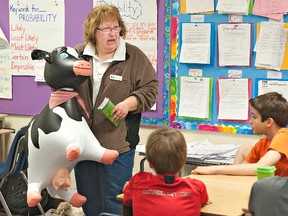 Joyce Clement uses an inflatable cow named Molly to talk about dairy farming with a class of Grade 5 and 6 students at Cedarland School. (BRIAN THOMPSON, The Expositor)