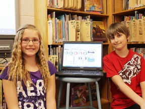 Grace Gowland and Ethan Rainford, Grade 5 students from Burford District Elementary School, demonstrate the Energy Dashboard for their classmates on Thursday.