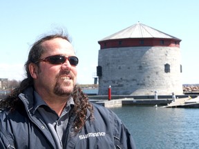 Paul Legacey, at Confederation Basin on Thursday, is trying to promote Kingston in the Ultimate Fishing Town online competition. (Ian MacAlpine/The Whig-Standard)