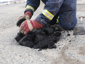 Kirsten Goruk/Daily Herald-tribune
Prairie Mall employee Richard Lafleur works at filling a pot hole near a south side entrance to the mall parking lot .The maintenance crew for the mall is always busy this time of year with what Lafleur calls “spring cleaning.”