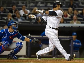 Yankees batter Robinson Cano watches the ball sail after he hit a three-run home run in front of Jays catcher J.P. Arencibia during last night’s game at Yankee Stadium. (REUTERS)