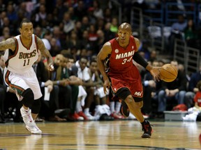 Ray Allen (right) of the Heat dribbles up the court against the Bucks during Game 3 of their Western Conference playoff series at Milwaukee's Bradley Center on Thursday, April 25, 2013. (Mike McGinnis/Getty Images/AFP)