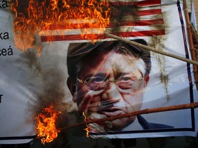 Protesters in Quetta last month burn an image of Gen. Pervez Musharraf, Pakistan's former leader, and a U.S. Flag to protest Musharraf's return to the country from exile to run for office once again. Anti-American sentiment and a long history of military rule are two legacies of the complex relationship between the two countries.