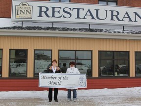 Celine Lagace, owner of The Station Inn being presented with the Board of Trade's 'Member of the Month' banner by Laura Labelle, Board of Trade VP.