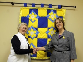 Fran Moore, left, one of many Paris volunteers who have canvassed the town for the Canadian Cancer Society during Daffodil Month, is thanked by Helen Schultz, the CCS's Brant-Norfolk unit manager, for more than 40 years of service. MICHAEL PEELING/The Paris Star/QMI Agency