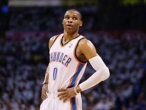 Oklahoma City Thunder guard Russell Westbrook takes a break on the court against the Houston Rockets in the second half of their Game 2 NBA Playoffs basketball game in Oklahoma City, Oklahoma April 24, 2013. (REUTERS/Bill Waugh)