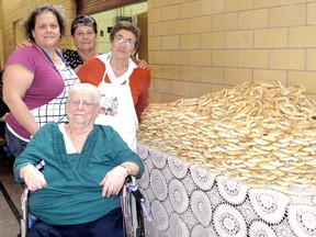 Esterina Cataldo, back left, sponsored the baking materials to make the bread that will be blessed for Sunday's 45th Feast Day in honour of the Virgin Mary, held by the local Italian community. She is pictured here with her mother Gerarda Sullo in front, Domenica DeMattia, back centre, and Gina Meriano, on Tuesday, April 23, 2013, in Chatham, Ont., during a social event to bake the bread. ELLWOOD SHREVE/ THE CHATHAM DAILY NEWS/ QMI AGENCY