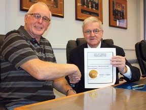 Timmins is officially on board for the Multiple Sclerosis (MS) Society of Canada's Carnation Campaign running from May 9-11. Director of fundraising for the Timmins chapter of the MS Society Lionel Gadoury, left, and acting mayor Coun. Michael Doody sealed the deal with a handshake at city hall on Friday.