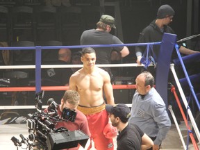 In this April 2013 file photo, Izaak Smith, middle, plays a boxer in A Fighting Man with trainer Gord Apolloni, right, who plays a referee. They take a break from shooting while the film crew gets the cameras set up for the next scene. (Chelsey Roach/for The Sudbury Star)