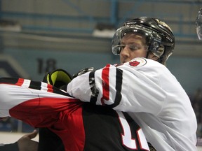 Brent Sauve of the Sarnia Legionnaires, right, puts a headlock on Kyle Brothers of the Lambton Shores Predators in a game this season. Sauve finished his final year with the Legionnaires and will attend Adrian College in Michigan the fall to play hockey. PAUL OWEN/THE OBSERVER/QMI AGENCY