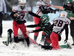 TERRY FARRELL/HERALD-TRIBUNE STAFF Bronco Taylor Rempel avoids the tackle from Shamrock Tyson Wenzel at the line, then runs 65 yards for a touchdown during a snowy MPBFL game at Legion Field in October 2012. Both Rempel and Wenzel were named to the Football Alberta Bantam Bowl to be played Monday, May 20 at Foote Field in Edmonton.