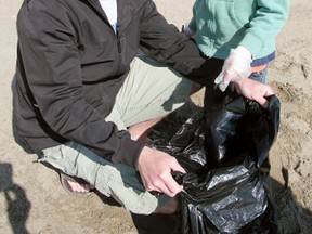 DANIEL R. PEARCE Simcoe Reformer
Jason Ouwendyk and his son Nolan, six, picked up garbage on Turkey Point beach Saturday morning as part of a nationwide effort to help keep the country's waterways clean.