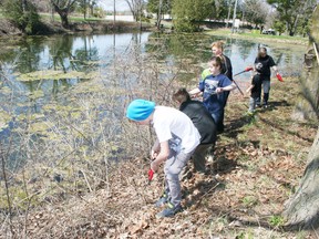 A group of volunteers trims the vegetation growing around Loweville Pond in Beachville on Saturday, April 27, 2013, during a clean up of the pond, Loweville Park and Beachville Road Park organized by the Beachville Parks and Recreation Committee. JOHN TAPLEY/INGERSOLL TIMES/QMI AGENCY