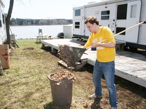 William McIntosh of Burlington, Ont., cleans up some leaves at his family's camp site at Pittock Conservation Area on Saturday, April 27, 2013. (JOHN TAPLEY, INGERSOLL TIMES file photo)
