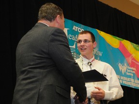 adam Jackson/Daily Herald-tribune
Jim Hancock, left, senior manager for the Grande Prairie district of ATCO, presents a Leaders of Tomorrow award to William Moutray on Friday at the TEC Centre. Moutray was among 12 youths, aged 13 to 18, who received awards.