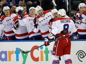 Teammates congratulate Washington Capitals left wing Alex Ovechkin (8) after he scored against the New York Rangers in the first period of their NHL hockey game at Madison Square Garden in New York March 24, 2013. (REUTERS)
