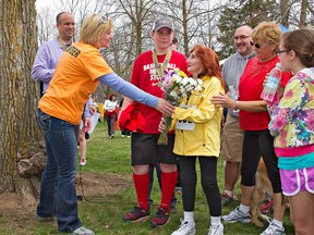 Pat Hamilton, 91, of St. George, receives a bouquet of flowers Sunday after finishing the 31st Rotary Classic Run from Paula Tysoski, the event's chair. (KARA WILSON, for The Expositor)