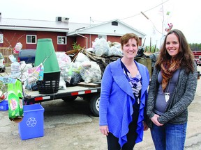 Darlene Pashak (left), family senior policy co-ordinator for the Municipality of Allumette Island, and Lisa Kelly, EcoFest co-ordinator, stand in front of a trailer containing just some of the garbage that was picked up Saturday during the community clean up.