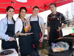 Timmins native and songwriter Celeste Levis, second from left, held a fundraising barbecue on the weekend in benefit of the Northern Ontario Families of Children with Cancer, part of her efforts in the Miss Northern Ontario Pageant that begins on May 2. Levis also has a song, So Called Hero, available on iTunes to add to her fundraising efforts. Helping out to flip burgers and hot dogs on Saturday were, from left, best friend Meagan McDonald, Levis’ boyfriend Steph Morin, and friend and Foodland employee John Wright.