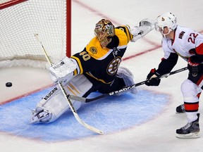 Boston Bruins goaltender Tuukka Rask (L) makes a save against Ottawa Senators right wing Erik Condra in the third period of their NHL hockey game in Boston, Massachusetts April 28, 2013.  REUTERS/Brian Snyder