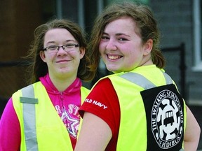 École Sir John A Macdonald Public School students (l-r) Emiliegh MacEwen and Rebecca Thompson show off the new safety vests they wear for the Walking School Bus pilot project with KFL&A Public Health. ROB MOOY - KINGSTON THIS WEEK