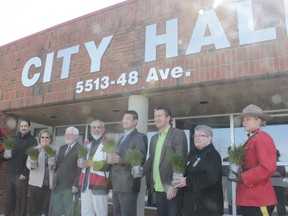 City of Cold Lake Mayor Craig Copeland (left) is presented with a sampling of the 303 seedling trees by Victim Services Coordinator David Zimmerman (right) outside City Hall on Earth Day.
