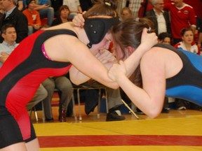 Amber Fergusson (left) gets into position on the mats against her opponent.