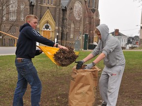 Josh Hamelin, left, and Ethan Johnston of the 870 Brockville Air Cadets, do their bit on the Court House Green on a gloomy Saturday morning for Brockville's annual Community Wide Clean-up. RONALD ZAJAC The Recorder and Times