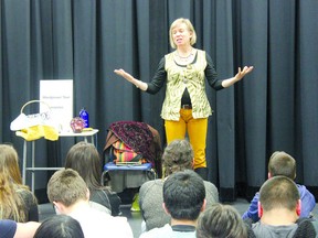 THERESA SERAPHIM/COLD LAKE SUN
Karen Gummo tells a story to Assumption Junior/Senior High School students 
on April 19 as part of Wordpower, an initiative that involves artists and storytellers doing sessions and reading in rural schools. Wordpower teams, brought to these places by the Young Alberta Book Society and Cenovus Energy, visited various schools in Bonnyville and Cold Lake as part of the initiative. Each school’s library also received a package of books by all participating artist