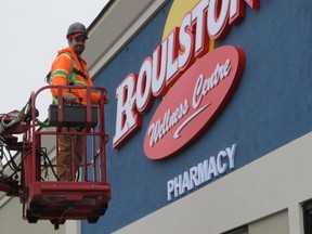 Roulston’s has postponed the opening of its new Wellness Centre on Donly Drive North in Simcoe. The store was originally set to open Thursday, May 2. Putting the finishing touches on the new signage Monday was Nelson Cabrell of Brooks Signs of Brantford.  (MONTE SONNENBERG Simcoe Reformer)
