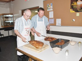 Rick Mckinnon, left, treasurer and Ralph Erdell, Anselmo Recreation & Agricultural Society second vice-president, serve roast beef, the signature entree of the Anselmo Spring Barbecue.
