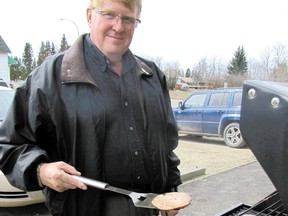 Mayerthorpe Mayor Kim Connell grills burgers on the sidewalk beside the Community Services Building in Mayerthorpe. The barbecue from 11 a.m. to 2 p.m. on Wednesday, April 24, is an annual event held to honour the town’s volunteers.