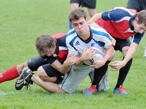 EDDIE CHAU Simcoe Reformer
Phil Guilmnette of the Simcoe Sabres, centre, is taken down by two members of the Waterford Wolves during a boy's rugby game at Simcoe Composite School Monday. Waterford defeated Simcoe 45-0.