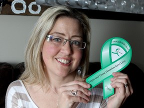 Double lung transplant recipient Shillane Labett holds up a Be A donor ribbon.
Ian MacAlpine The Whig-Standard