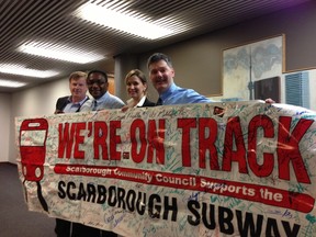 Councillors (from right) Glenn De Baeremaeker, Michelle Berardinetti, Michael Thompson and Gary Crawford roll out a 2006 Scarborough subway banner Monday, April 29, 2013, to make their point it is time to revive the push for a subway into the eastern suburb. (DON PEAT/TORONTO SUN)