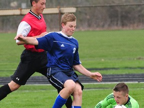 Parkside's Cole Spiering, middle, pushes the ball past scrambling Arthur Voaden goalkeeper Jarred Tuckey in front of Vikings defender Sam Heathorn in their TVRA South soccer opener Monday at PCI. Simpson's ball didn't find the net, but the Stampeders won 4-1.  (R. MARK BUTTERWICK, St. Thomas Times-Journal)