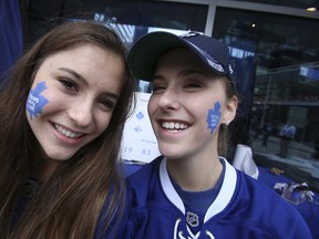 Madison Erhardt, left, and twin sister Alexandra show off their Leaf colours before the contest Monday, April 29, 2013, to win free playoff tickets. Madison ended up winning lower-bowl seats. (Jack Boland/Toronto Sun)