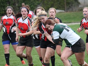 Players fight for possession of the ball during a Paris District High School senior girls rugby home game against the St. John's Green Eagles on Monday. The Panthers won 31-12. (MICHAEL PEELING, QMI Agency)