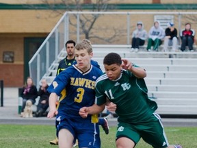 Napanee Golden Hawks’ Matt Griffin and Holy Cross Crusaders’ Devon Christian race for possession of the ball during a Kingston Area Secondary Schools Athletic Association senior boys soccer game at Holy Cross on Monday. The Crusaders won 5-1. (Julia McKay/For The Whig-Standard)