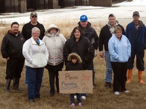 Protesters pictured in front of the Portage Diversion, Monday afternoon, where they were protesting the lack of compensation they received from the provincial government for the flood of 2011. By 11 p.m. Monday night they had moved the farm equipment they had placed in the diversion and the gates of the diversion were allowed to open. (ROBIN DUDGEON/THE GRAPHIC/QMI AGENCY)